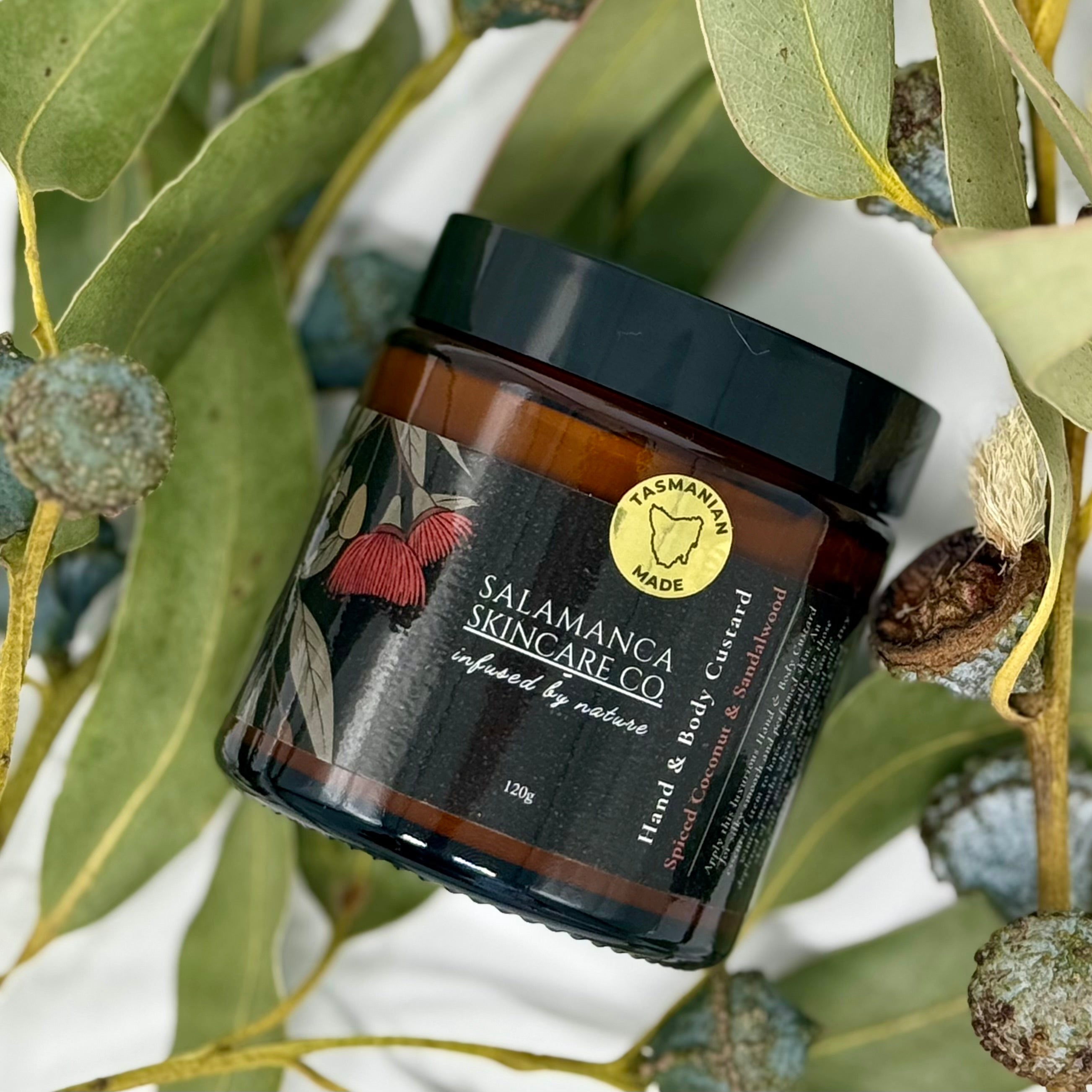 Jar of Salamanca Skincare Co product on a branch with leaves and buds